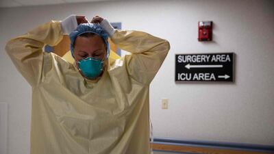 A healthcare professional suits up with PPE at Van Wert County Hospital in Van Wert, Ohio, November 20, 2020. AFP