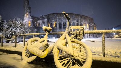A bycicle is covered by snow in front of the Colosseum during a snowfall in Rome. Angelo Carconi / EPA