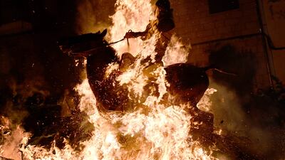 A horseman rides through a bonfire in the village of San Bartolome de Pinares in the province of Avila in central Spain, during the religious festival of 'Las Luminarias' in honour of San Antonio Abad, patron saint of animals. AFP