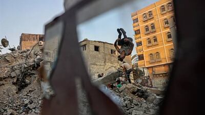 Palestinian youths practise parkour amid the rubble of buildings destroyed by Israeli air strikes in the latest round of fighting between Israel and Palestinian militants, in Rafah in the southern Gaza Strip.