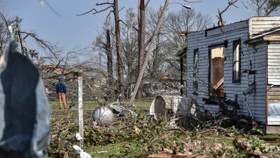 A resident in Silver City surveys the damage. AP