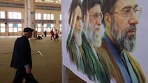 A poster depicts Iranian leaders at a commemoration event for those killed in war. AFP