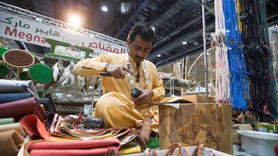 A worker makes the head hood of a falcon at Adihex. Leslie Pableo for The National