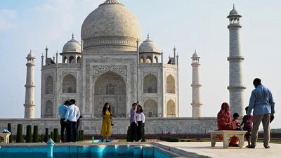 Tourists at the Taj Mahal after it reopened to visitors when authorities eased coronavirus restrictions in Agra. AFP