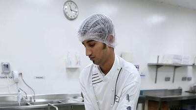A chef prepares fruit salad inside the kitchen at Dubai World Trade Centre in Dubai. Pawan Singh / The National