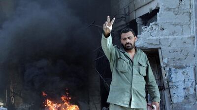 A Syrian soldier poses for the camera in al-Hajar al-Aswad neighborhood in south Damascus, on May 21, 2018. EPA