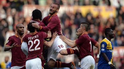 AS Roma forward Francesco Totti (unseen) is congratulated by teammates (from left) Maicon, Mattia Destro, Gervinho, Daniele De Rossi and Taddei after scoring against Parma during their Serie A at the Stadio Olimpico on Wednesday. Filippo Monteforte / AFP / April 2, 2014