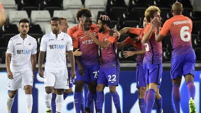 Manchester City’s Gael Clichy celebrates scoring their first goal with teammates. Rebecca Naden / Reuters