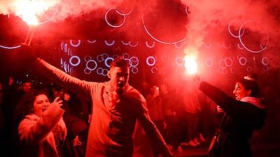 Supporter hold smoke flares as they celebrate France's victory over Morocco in the Qatar 2022 World Cup semi-final, in Marseille on December 14, 2022. (Photo by Nicolas TUCAT / AFP)