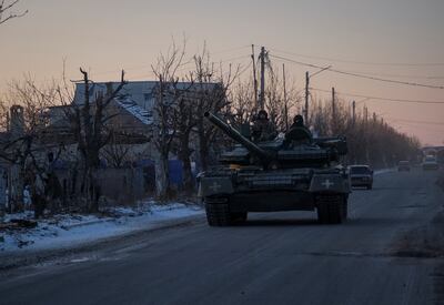 Ukrainian servicemembers ride a tank near the town of Lyman, Donetsk region, as Russia's attack on Ukraine continues. Reuters