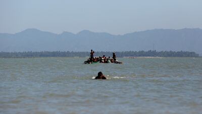 Rohingya refugees arrive on a makeshift boat after crossing the Bangladesh-Myanmar border, at Shah Porir Dwip near Cox's Bazar, Bangladesh. Navesh Chitrakar / Reuters