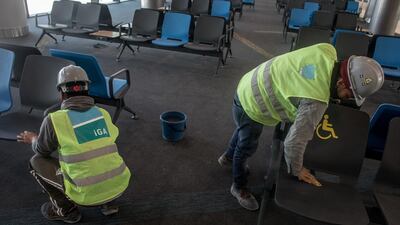 Airport employees clean chairs in the completed hall "B" section. Getty Images