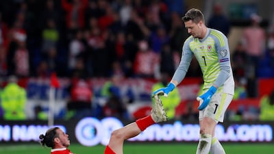 Soccer Football - Euro 2020 Qualifier - Group E - Wales v Croatia - Cardiff City Stadium, Cardiff, Britain - October 13, 2019 Wales' Gareth Bale is helped by Wayne Hennessey during the match Action Images via Reuters/Andrew Couldridge