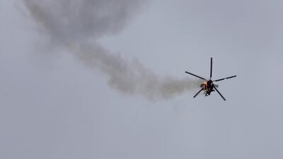 A Syrian government helicopter bursts in flames after it was hit by a missile in Idlib province on February 11, 2020. AP