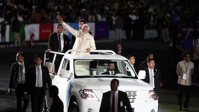 The Prime Minister of India waves to the crowd after his speech