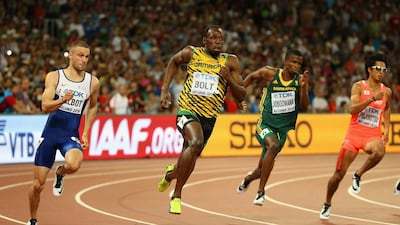Usain Bolt, centre, won his semi-final as he bids to add 200m gold to the 100m title he won on Sunday. Andy Lyons / Getty Images