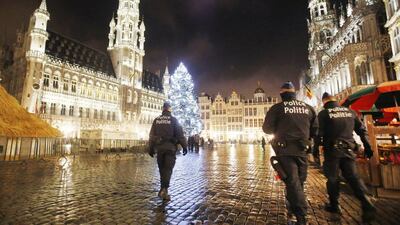 Belgian police officers patrol the Grand Place in downtown Brussels. The Belgian capital Brussels has entered its third day of a lockdown. The US State Department has issued a global travel alert in the wake of the Paris attacks. Michael Probst / AP Photo