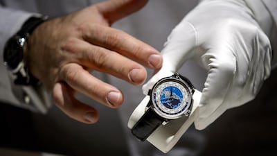 An employee of Montblanc owned by Richemont, the world's second-largest luxury goods firm, shows a new watch model on the opening day of the "Salon International de la Haute Horlogerie" (SIHH), a professional fair in fine watchmaking, on January 19, 2015, in Geneva. Fabrice Coffrini / AFP