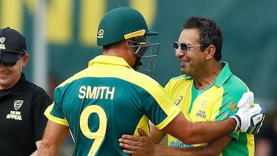 Pakistan great Wasim Akram, right, shares a laugh during the Bushfire Cricket Bash T10 match between the Ponting XI and the Gilchrist XI at Junction Oval in Melbourne, Australia. Getty Images