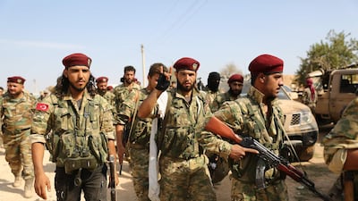 Turkey-backed Syrian fighters gather on the outskirts of the key Syrian border town of Ras al-Ain on October 16, 2019 during the ongoing assault by Turkey and its allies on Kurdish-held border towns in northeastern Syria. Turkey rebuffed international pressure to curb its military offensive against Kurdish militants in Syria today as US President Donald Trump dispatched his deputy Mike Pence to Ankara to demand a ceasefire. / AFP / Nazeer Al-khatib