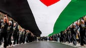 A giant Palestinian flag is carried through Ramallah, in the occupied West Bank, to commemorate 78 years since the Nakba. AFP