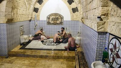 Men gather in the bathhouse in the northern Syrian city.