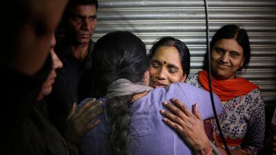 Asha Devi, mother of the victim of the fatal 2012 gang rape and murder on a moving bus in New Delhi is embraced by an unidentified woman after the rapists of her daughter were hanged. AP Photo