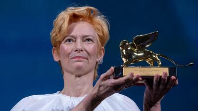 Tilda Swinton holds her Golden Lion For Lifetime Achievement award. AP