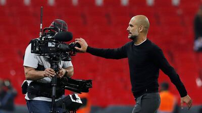 Manchester City manager Pep Guardiola blocks a camera with his hand after the match. Andrew Couldridge / Reuters