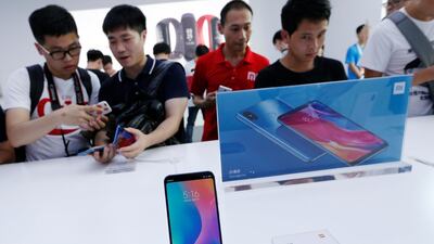 Fans check the new Xiaomi flagship Mi 8 during a product launch in Shenzhen. Xiaomi faces stiff competition not just from Apple and Samsung, but also from Chinese giant Huawei, REUTERS/Bobby Yip