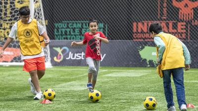 Children practice football drills at the six-week summer camp.