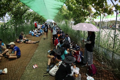 Participants shelter from the sun at the campsite for the 25th World Scout Jamboree in Buan. Reuters
