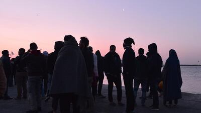 Migrants who camp out at the port of Chios watch the arrival of a Turkish catamaran to carry the first group of migrants to be sent back to Turkey. Under a new agreement, designed to halt the main influx which comes from Turkey, all “irregular migrants” arriving since March 20 face being sent back, although the deal calls for each case to be examined individually. Louisa Gouliamaki / AFP