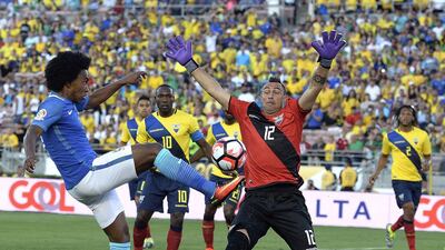 Brazil’s Willian takes a shot on goal against goalkeeper Esteban Dreer of Ecuador. Kevork Djansezian / Getty Images
