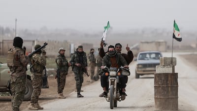 The Syrian flag is raised next to an army checkpoint on the outskirts of Hasakah. Reuters