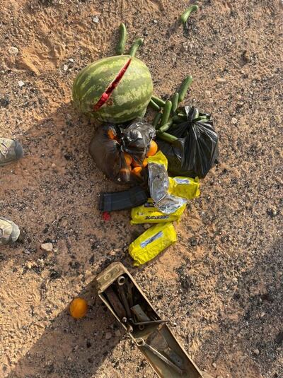 Fruit and vegetables next to ammunitions and tools on the ground near the damaged truck.