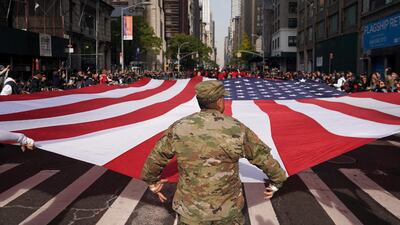 People carry a giant American flag up Fifth Avenue during the New York City Veterans Day Parade. AP