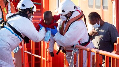 A Spanish Sea Rescue ship takes a baby, among 68 rescued migrants, to Arguineguin, in the Canary Islands, on August 12. EPA