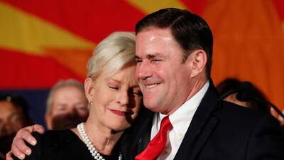 Republican Arizona Governor Doug Ducey embraces Cindy McCain, wife of the late US Senator John McCain while speaking to supporters at the GOP party in Arizona. AP