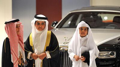 Saudi boys visit the Rolls Royce stand at the 2013 International Luxury Motor Show in Riyadh, Saudi Arabia. Fayez Nureldine / AFP