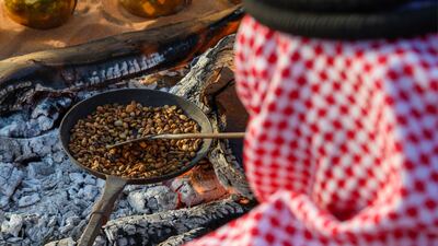 Coffee beans being lightly roasted in a cast-iron pan over an open fire. Photo: Ministry of Culture