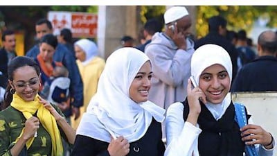 Moroccans use their mobile phones on a Rabat street. The country's government owns 30 per cent of Maroc Telecom and has to approve of any stake transaction. Abdelhak Senna / AFP