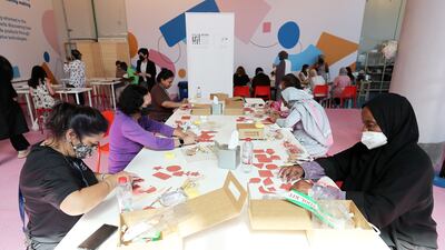 Participants making craft items in the art workshop on the opening day of Dubai Design Week