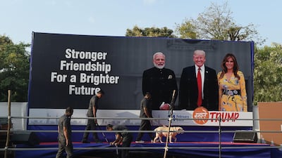 Gujarat police's bomb detection disposal squad officials along with a sniffer dog inspect a stage displaying pictures of India's Prime Minister Narendra Modi, US President Donald Trump and First Lady Melania Trump, on the outskirts of Ahmedabad, ahead of Trump's visit to India. AFP
