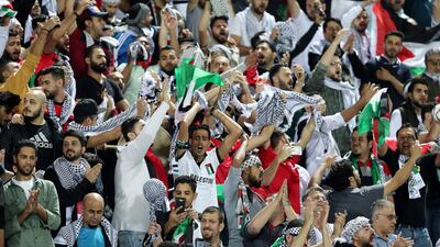 Passionate Palestine fans cheer on their side in their opening Asian Cup clash against Syria. Pawan Singh / The National