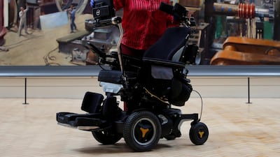 Kate Perks, senior collections care conservator at London's Science Museum, with the wheelchair of Prof Stephen Hawking. Reuters