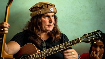 Lanny Cordola watches over a group music lesson at ‘Miraculous Love Kids’, an organisation in Kabul, that provides music training to children working on the streets of Kabul. Ivan Flores for The National