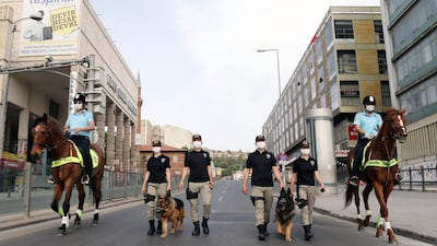 Ankara's mounted police unit officers patrol with dogs the streets in the Ulus district in Ankara, Turkey. AFP