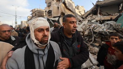 Wounded Palestinian Nidal Al Gharib, who lost his wife and daughter, walks past houses in his community destroyed by an Israeli bombardment in Rafah in the southern Gaza Strip. AFP