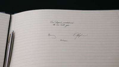 A picture shows the message written and signed by Meghan, Duchess of Sussex and Prince Harry, Duke of Sussex at the New Zealand High Commission in London. AFP